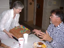 Nancy presenting cake to Todd